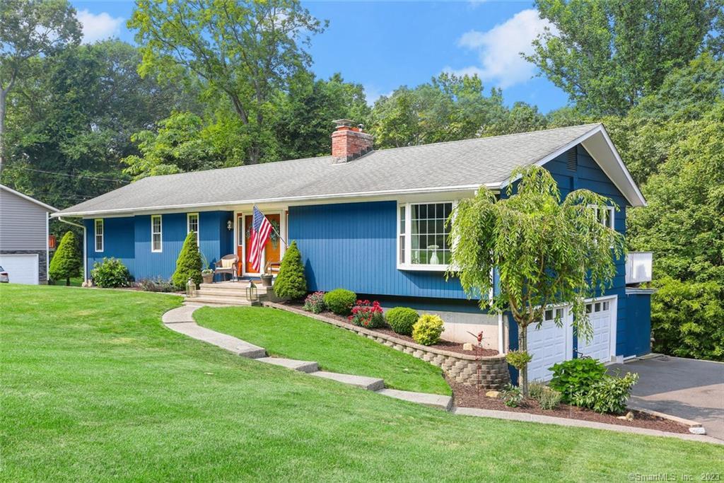 47 Greenbrier Road Trumbull, CT 06611 - Photo 1 of 1 a front view of a house with a yard table and chairs