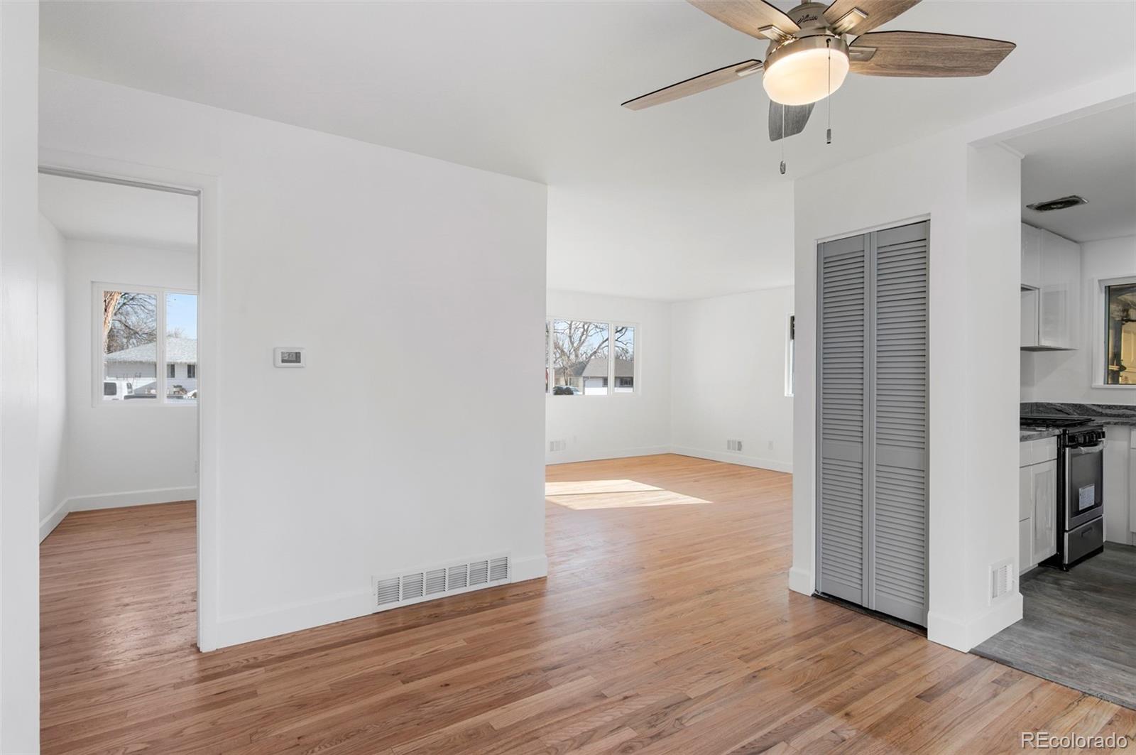 7483 Knox Court Westminster, CO 80030 - Photo 13 of 35 an empty room with wooden floor and entryway