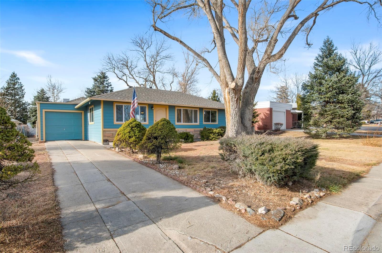 7483 Knox Court Westminster, CO 80030 - Photo 2 of 35 a front view of a house with garden