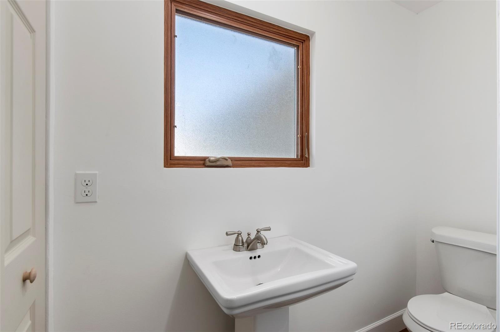 7483 Knox Court Westminster, CO 80030 - Photo 27 of 35 a bathroom with a sink and a toilet