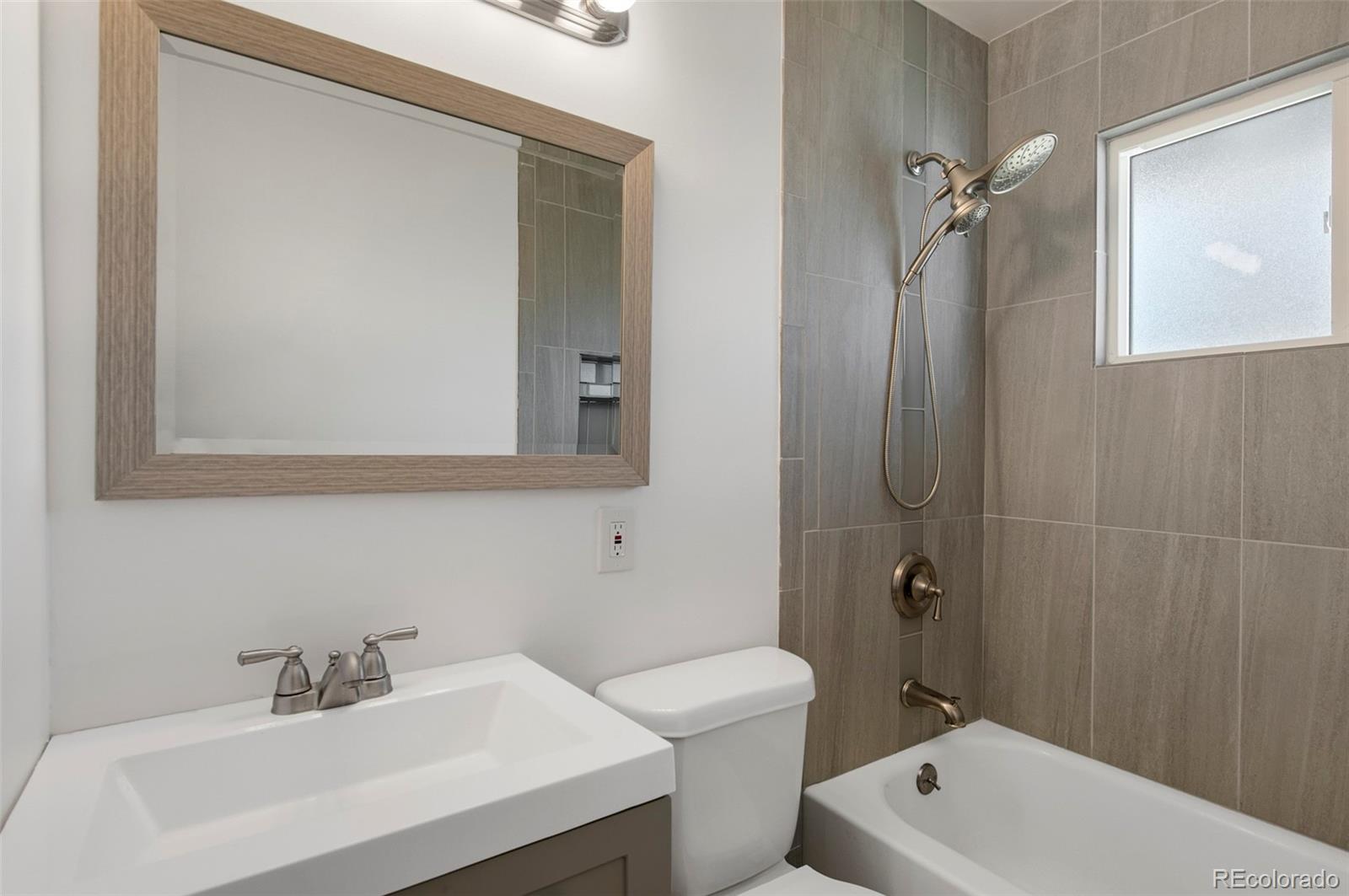 7483 Knox Court Westminster, CO 80030 - Photo 29 of 35 a bathroom with a sink a toilet and shower