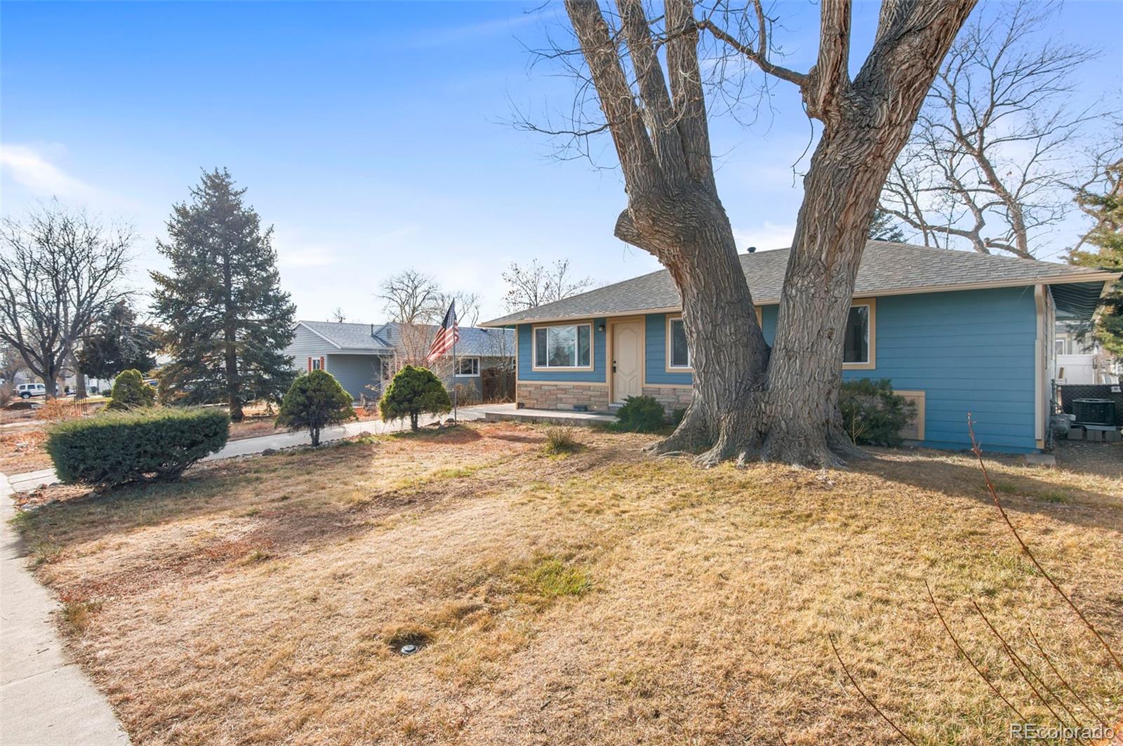 7483 Knox Court Westminster, CO 80030 - Photo 3 of 35 a view of a house with a yard
