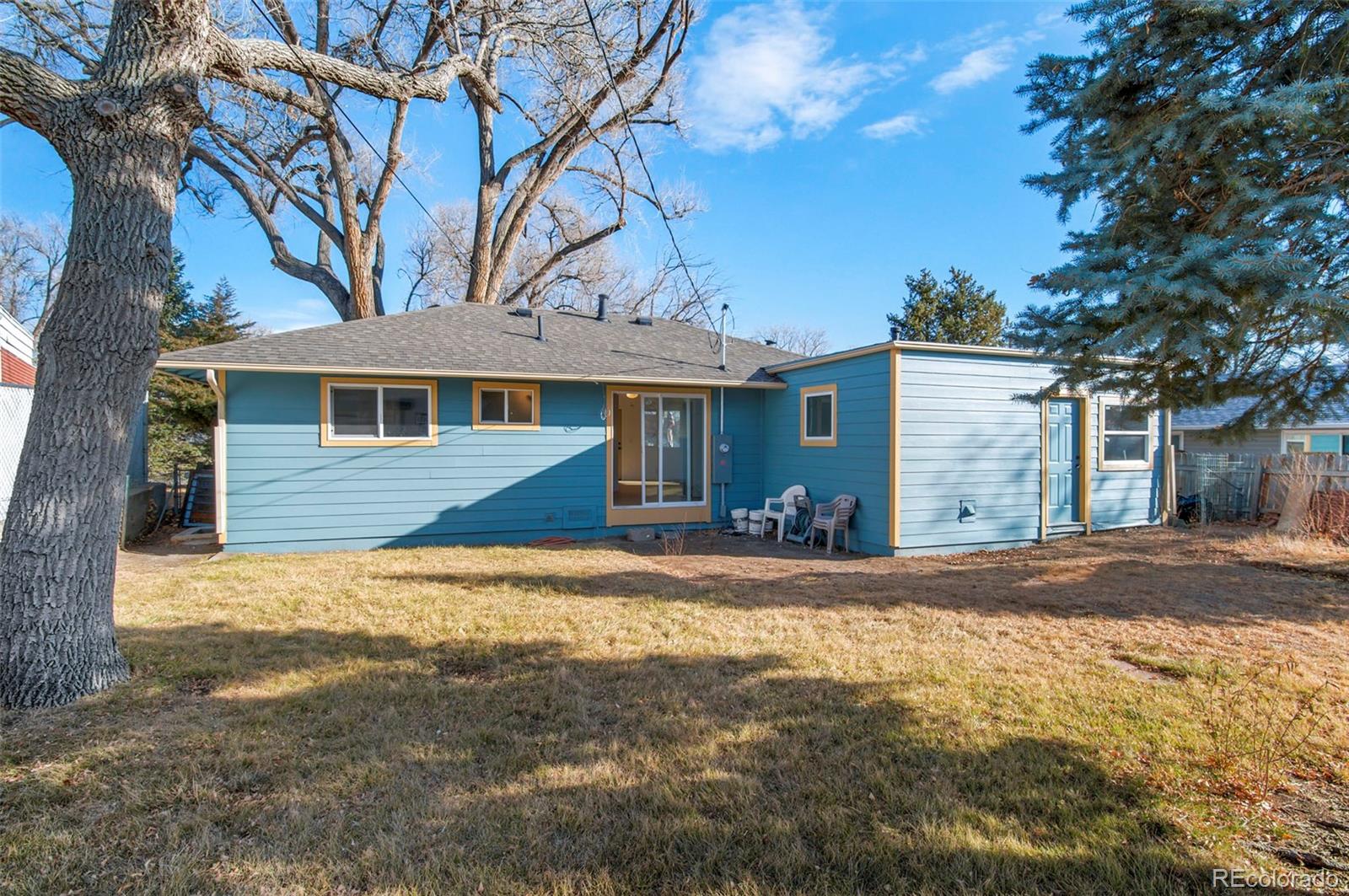 7483 Knox Court Westminster, CO 80030 - Photo 32 of 35 a view of a yard in front of a house with large tree