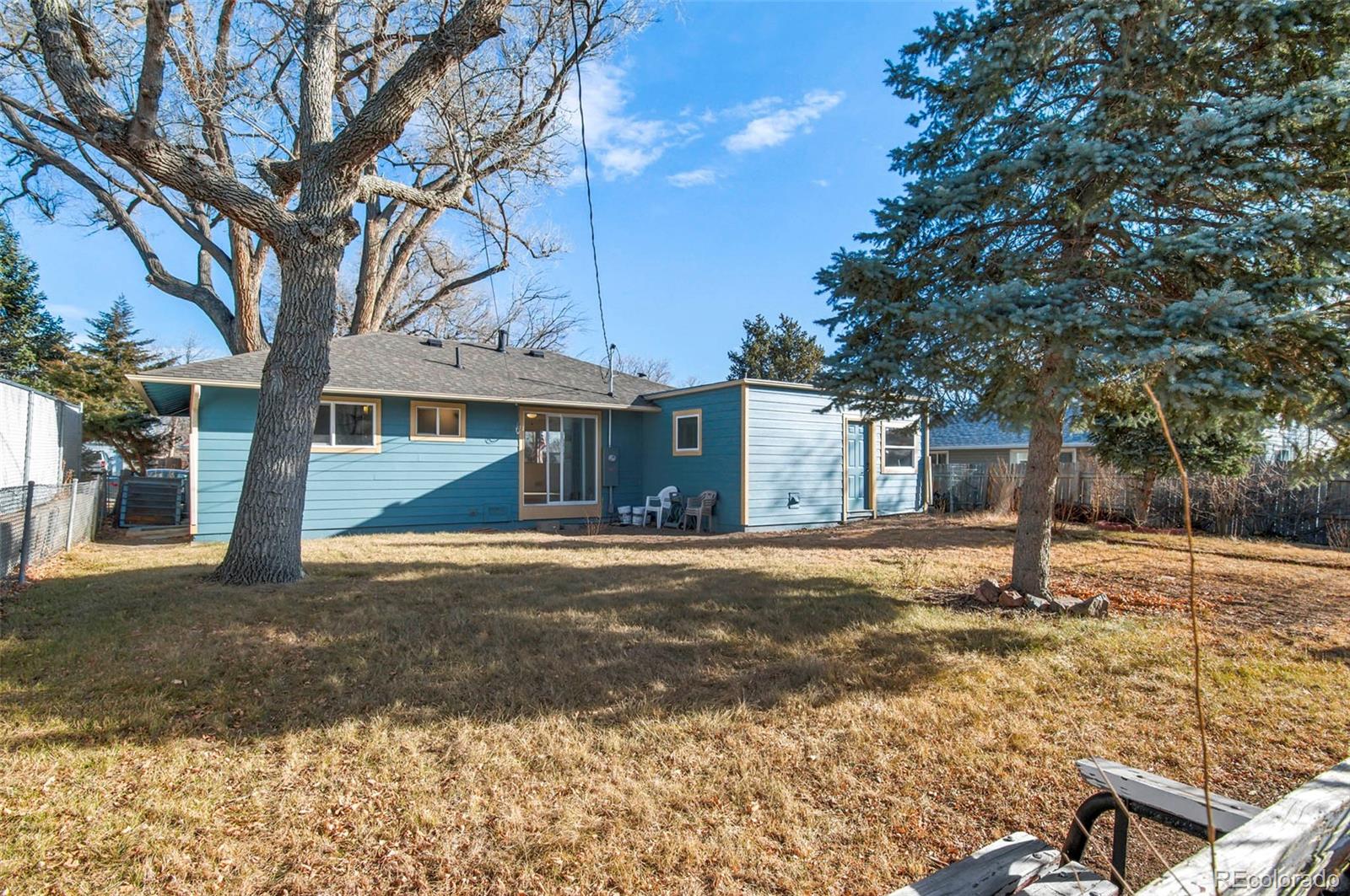7483 Knox Court Westminster, CO 80030 - Photo 33 of 35 a house with trees in the background