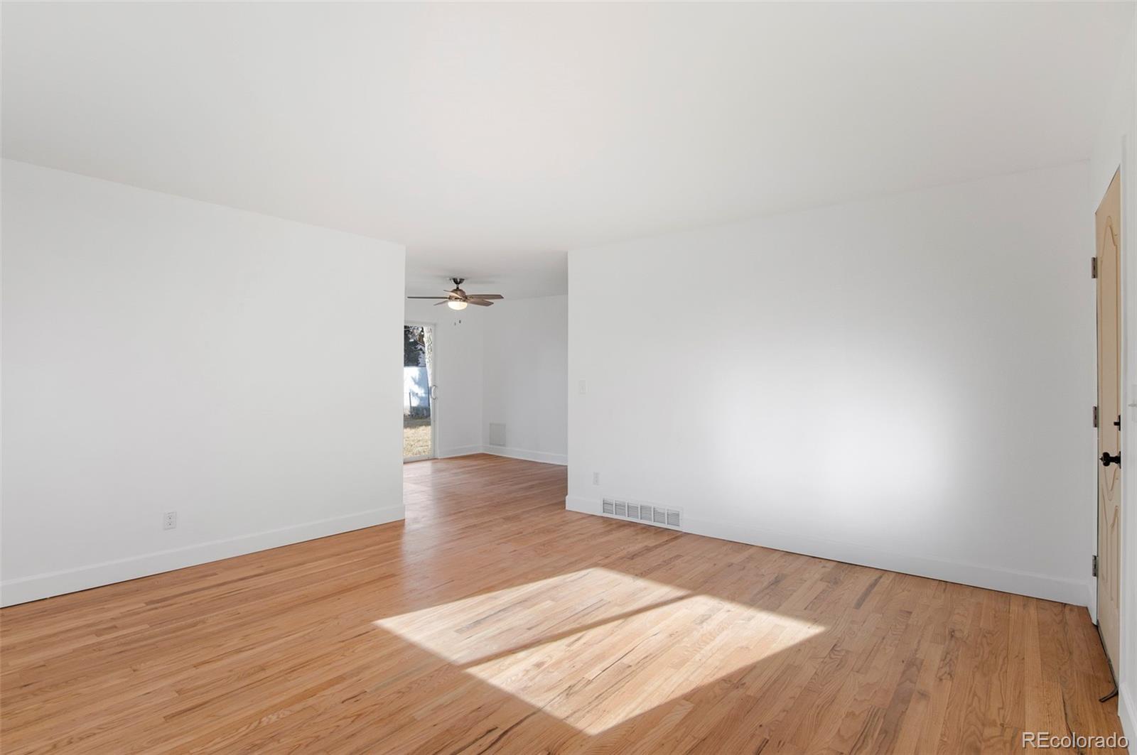 7483 Knox Court Westminster, CO 80030 - Photo 10 of 35 a view of an empty room and wooden floor