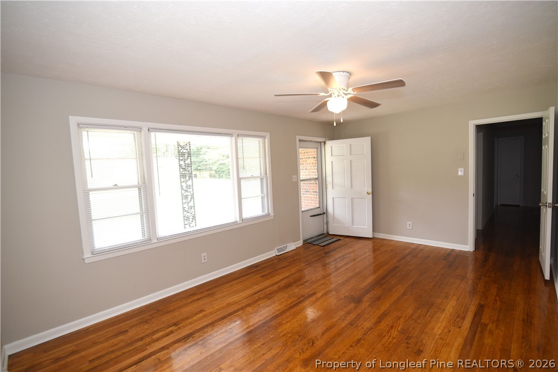 1673 Norment Road Lumberton, NC 28360 - Photo 3 of 32 an empty room with wooden floor and windows