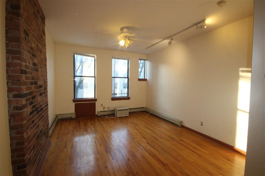 112 Jefferson Street, Unit 2S Hoboken, NJ 07030 - Photo 2 of 13 a view of an empty room with a window and wooden floor