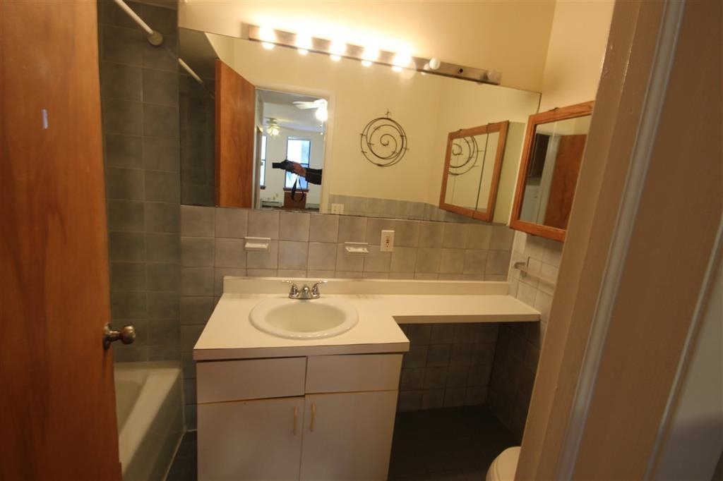 112 Jefferson Street, Unit 2S Hoboken, NJ 07030 - Photo 7 of 13 a bathroom with a sink and a mirror