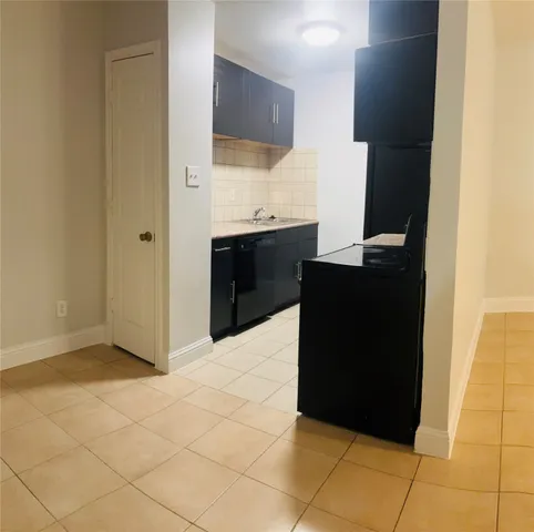 a kitchen with a sink a refrigerator and a stove