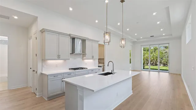 a large white kitchen with cabinets