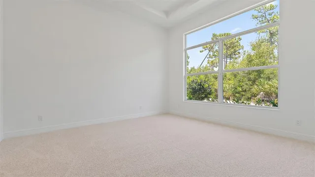 an empty room with wooden floor and a window