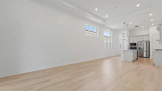 a view of a kitchen with refrigerator and a microwave