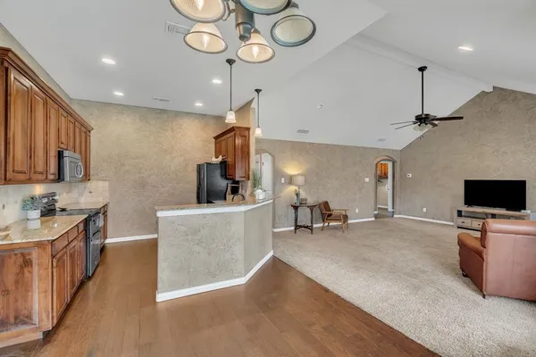 a bathroom with a double vanity sink a large mirror and a bathtub