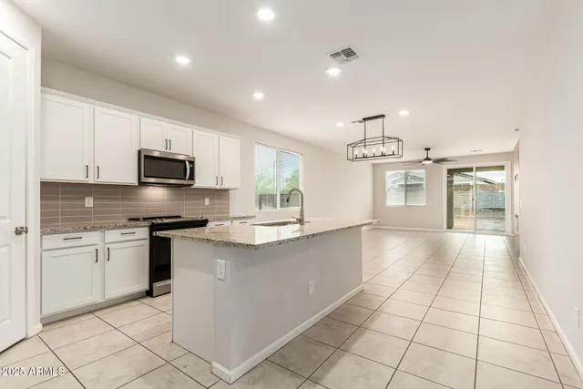a kitchen with stainless steel appliances granite countertop a sink and cabinets