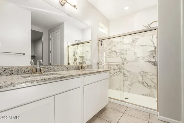 a bathroom with a granite countertop sink and a bathtub