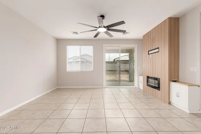a view of an empty room with a fireplace and a window
