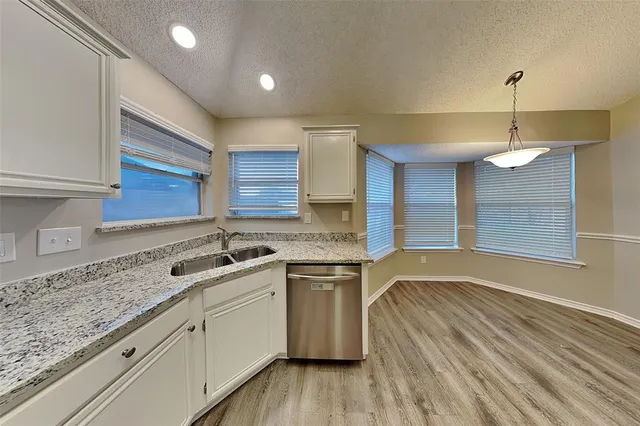 a kitchen with a sink stove and cabinets