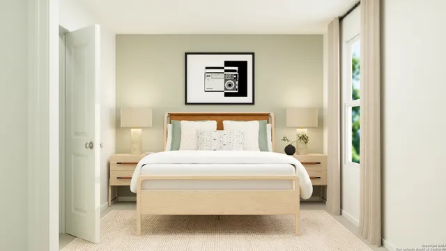 a bedroom with a bed and a painting on the wall