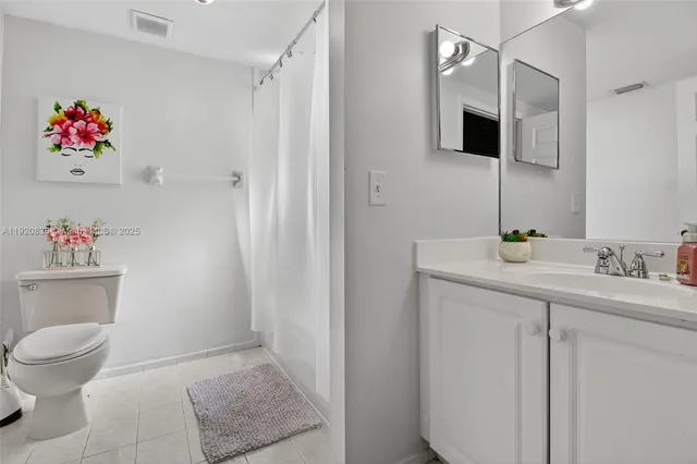 a bathroom with a toilet sink and a mirror