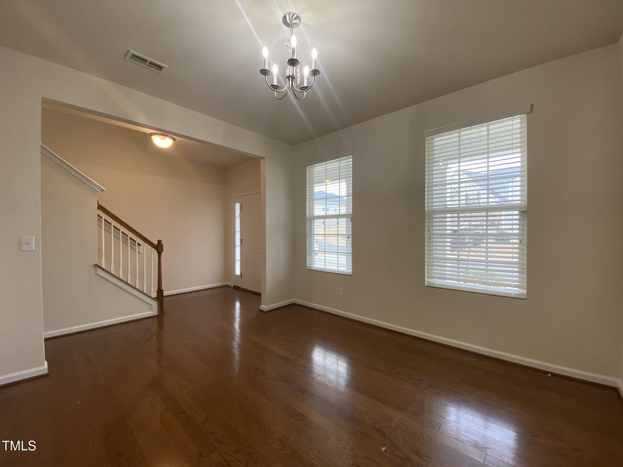 3545 Massey Ridge Court Raleigh, NC 27616 - Photo 6 of 38 a view of an empty room with wooden floor and a window