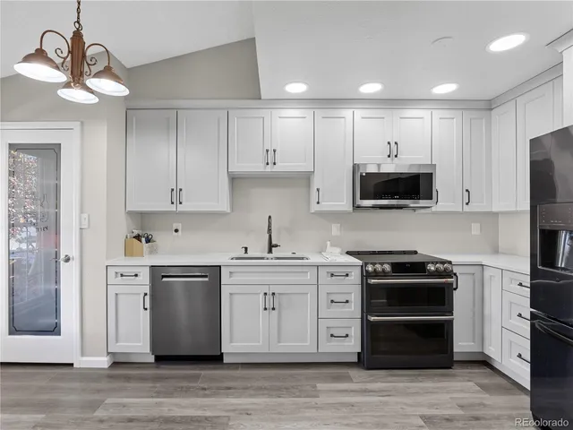 a kitchen with stainless steel appliances a stove sink and cabinets