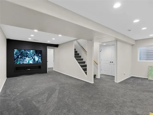an empty room with furniture and a ceiling fan