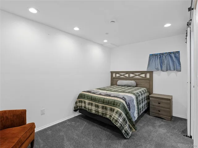 a spacious bedroom with a bed and a couch