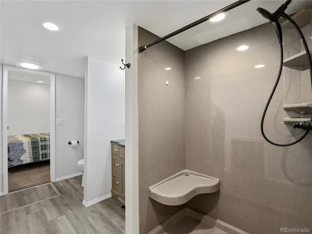 a bathroom with a toilet and a shower
