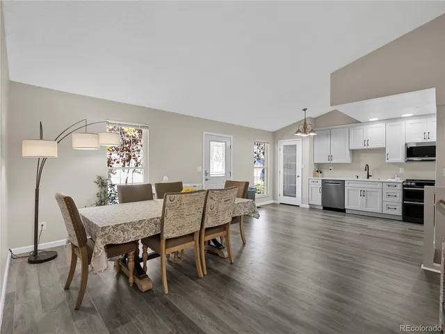 a view of a dining room with furniture and wooden floor