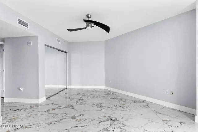 a view of wooden floor and a window in a room