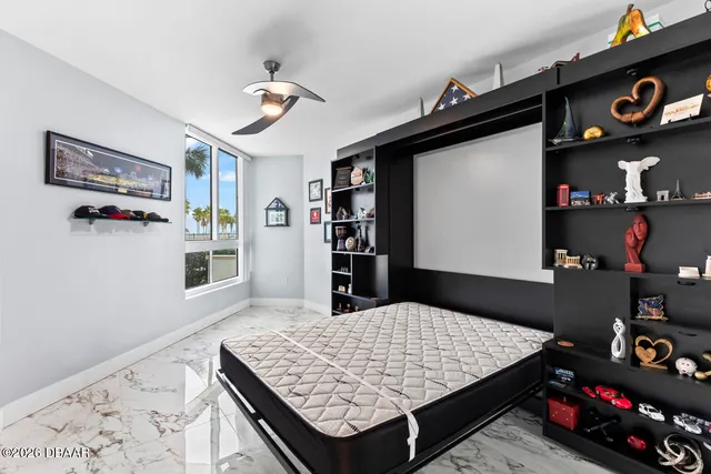 a view of a big room with wooden floor and windows
