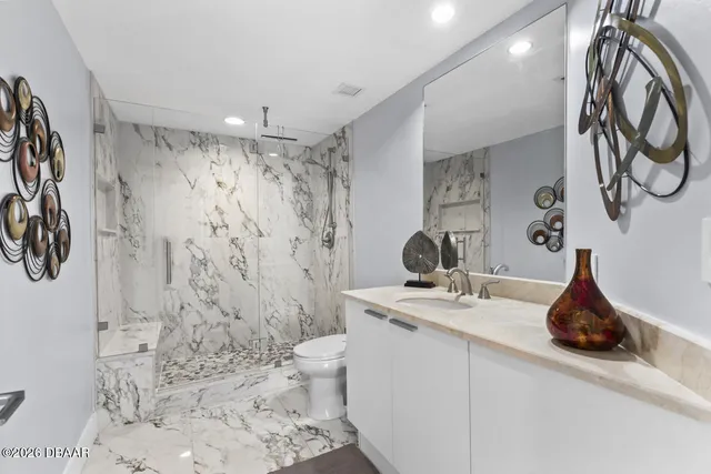 a view of a swimming pool and outdoor seating