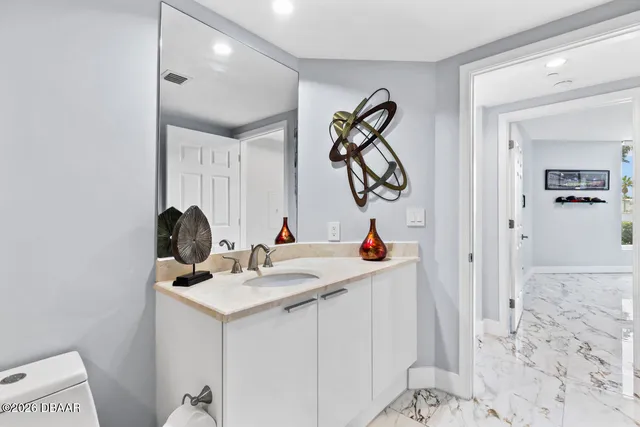a large white kitchen with a large window and floor to ceiling window