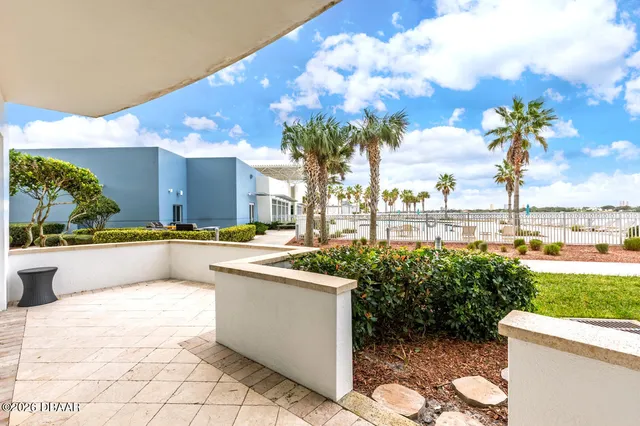 a view of swimming pool with outdoor seating and plants