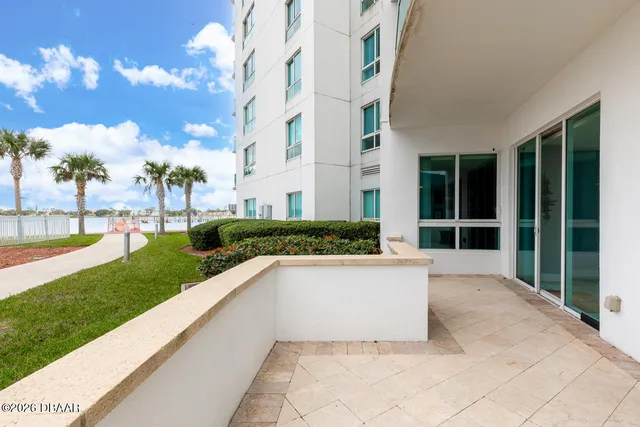 a view of a park with a apartment building in the background