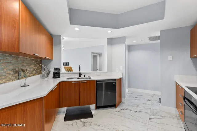 a kitchen with stainless steel appliances a sink stove and cabinets