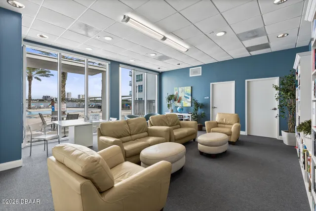 a living room with lots of furniture and wooden floors