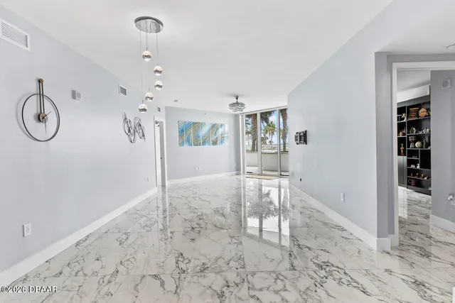 a view of a livingroom with wooden floor and furniture