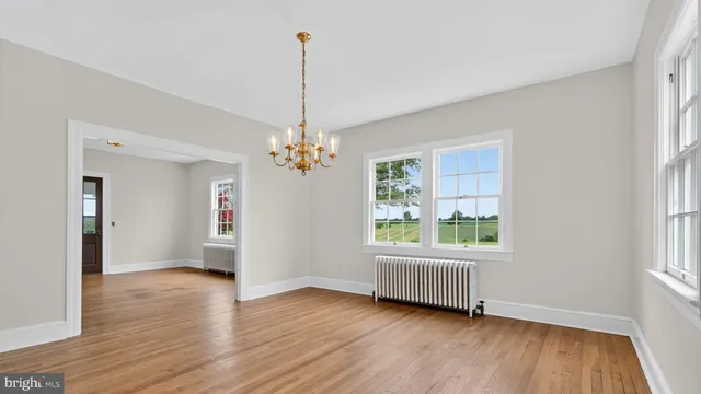 a view of staircase with wooden floor and white walls