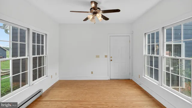 a workspace with wooden floor and windows