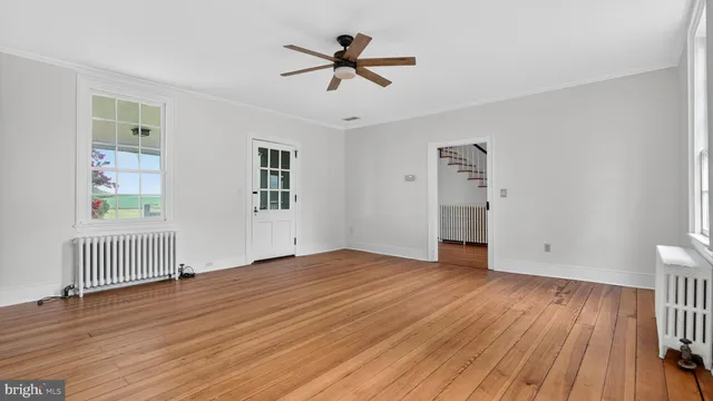 a view of an empty room with wooden floor