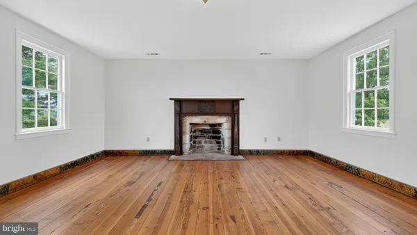 an aerial view of a house with pool yard and mountain view in back