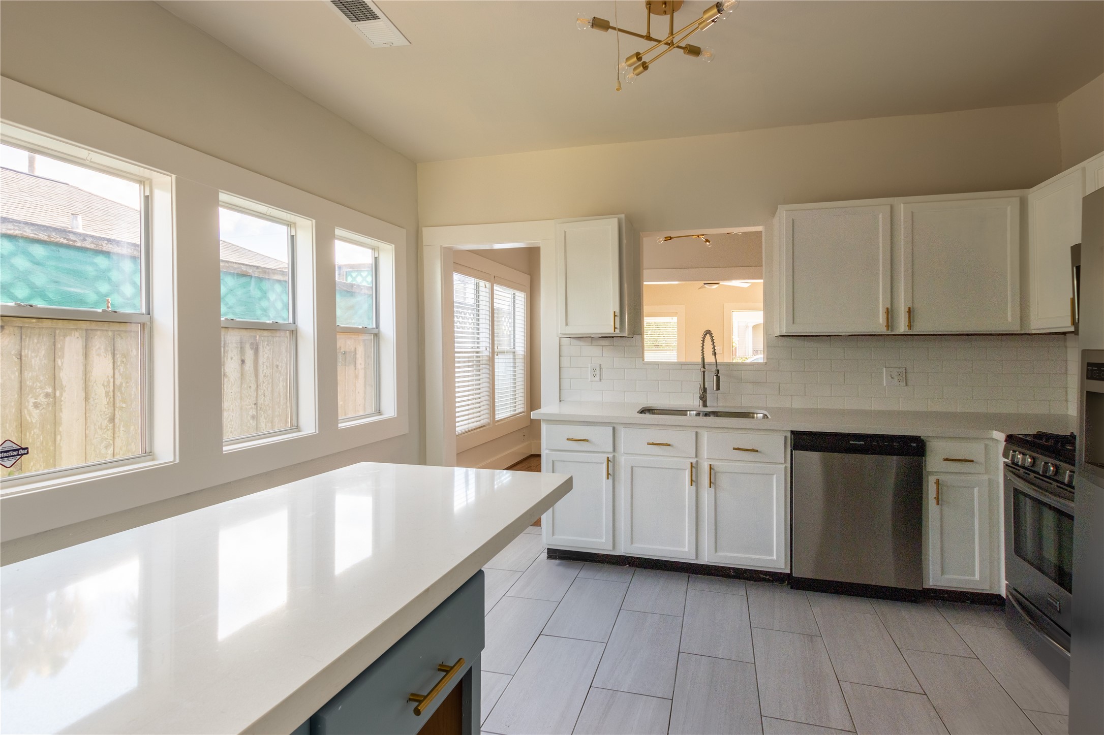 2009 Singleton Street Houston, TX 77008 - Photo 14 of 24 a large kitchen with stainless steel appliances granite countertop a sink and a stove