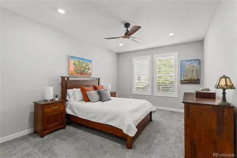 a bedroom with a bed a couch and a window