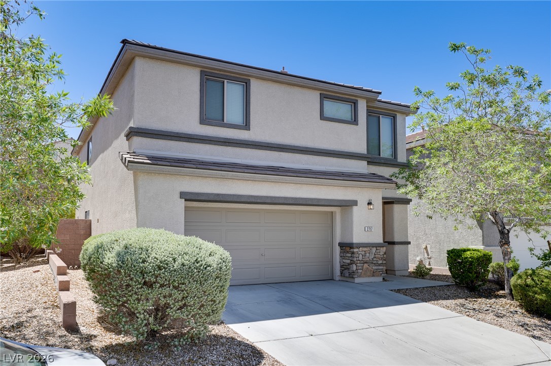 2717 Rimbaud Street Henderson, NV 89044 - Photo 3 of 34 A well-maintained stucco home offers a two-car garage and manicured landscaping.