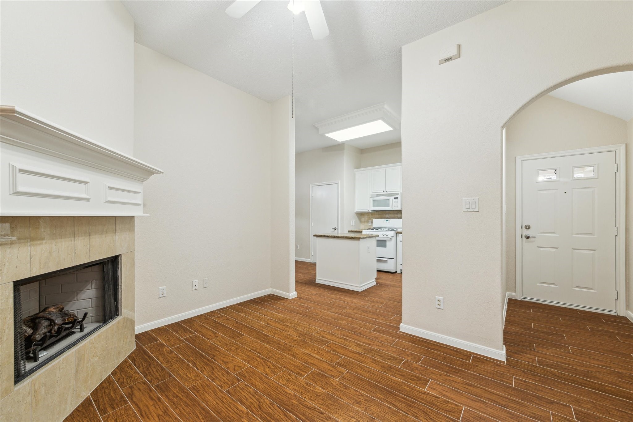 2806 Crescent Star Road Spring, TX 77388 - Photo 7 of 23 a view of a kitchen and an empty room with wooden floor