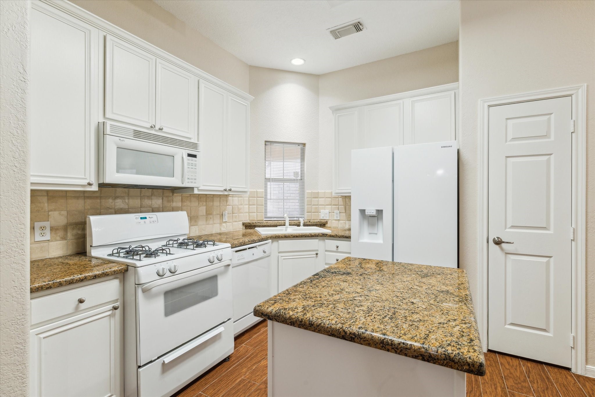 2806 Crescent Star Road Spring, TX 77388 - Photo 8 of 23 a kitchen with white cabinets and white appliances