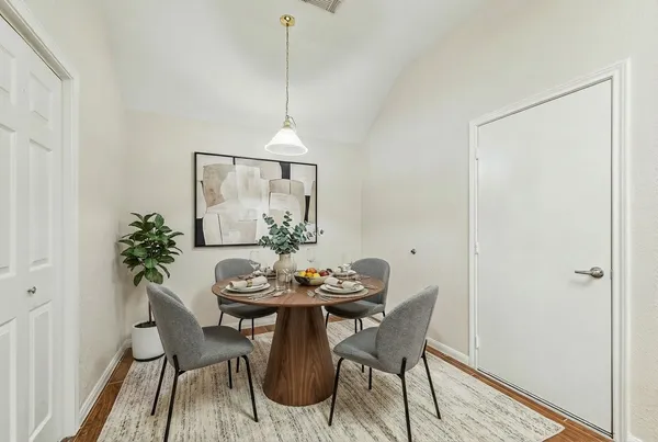 a dining room with furniture and wooden floor