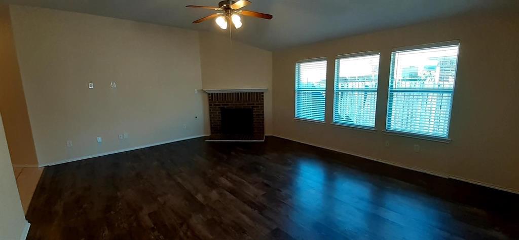 3005 Mill Creek Way Forney, TX 75126 - Photo 6 of 10 a view of an empty room with wooden floor and a window
