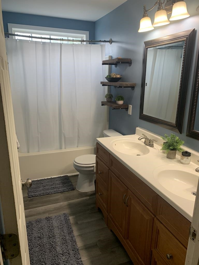 700 Hanska Way Raleigh, NC 27610 - Photo 3 of 3 Ensuite Master bath has dual vanities, laminate flooring with transom above shower/tub combo... Ensuite Master Bath
